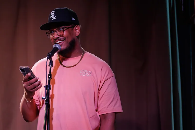 A combatant reading from his phone at the microphone