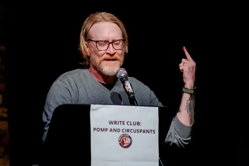 A combatant at the lectern with one finger raised