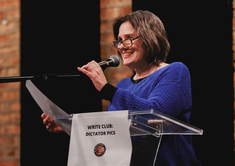 A combatant reading from loose pages at the lectern