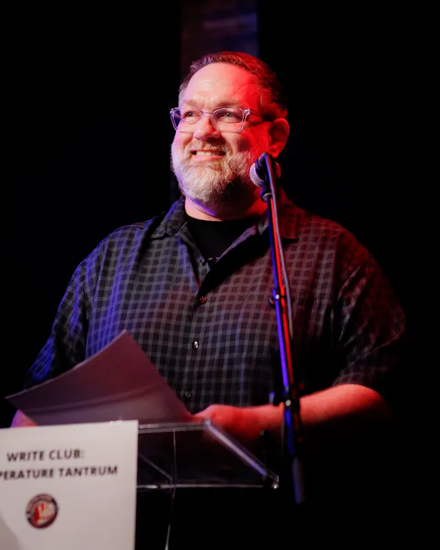A combatant reading from pages under red light