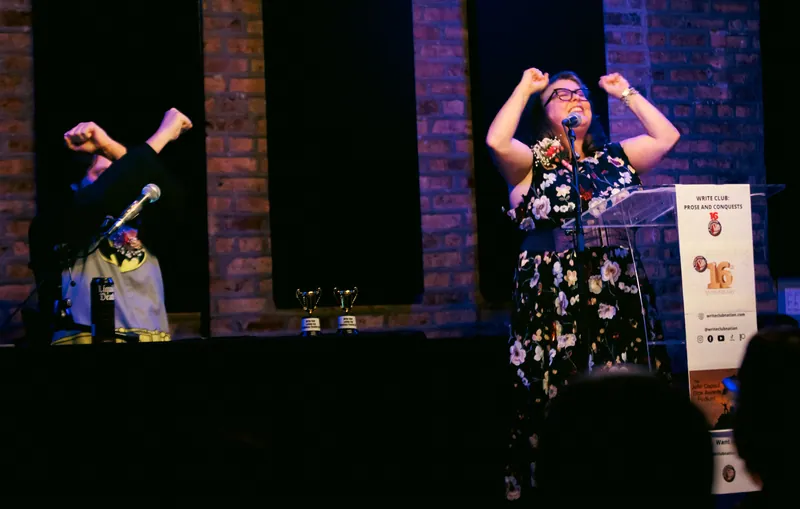 Two combatants with fists raised at the end of a bout